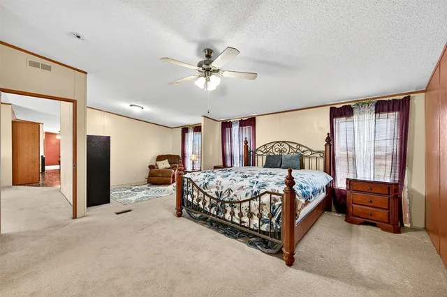 a bedroom with a bed and dresser