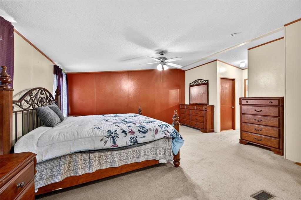 12085 Keys Road Marietta, OK 73448 - Photo 36 of 40 a bedroom with a bed and dresser