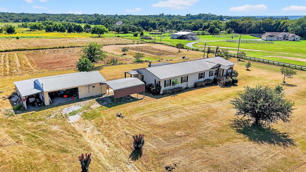 12085 Keys Road Marietta, OK 73448 - Photo 8 of 40 a view of a lake with lawn chairs and large trees