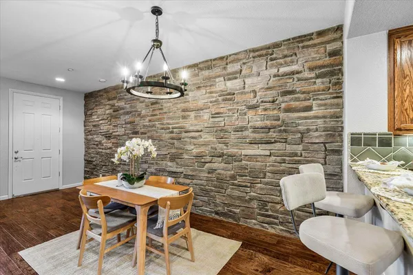 a dining room with furniture and a chandelier