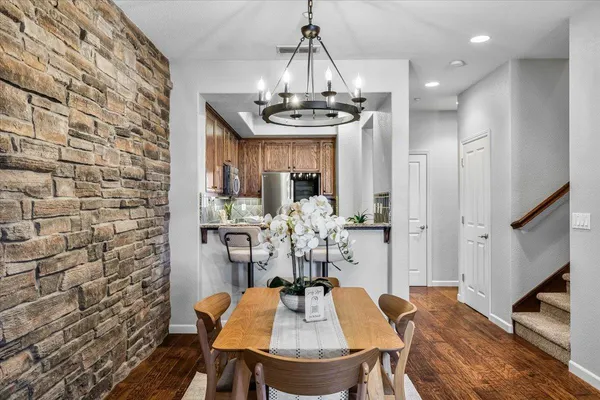 a view of a dining room with furniture wooden floor and chandelier