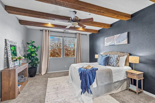 a bedroom with a bed and a potted plant