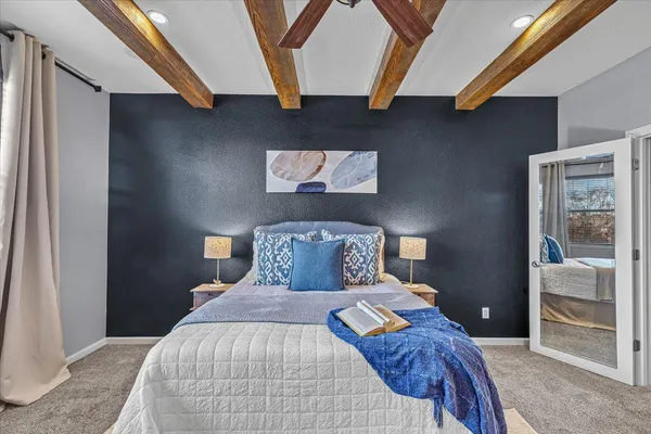 a bedroom with a bed and a painting on the wall