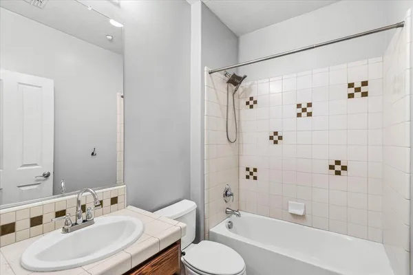 a bathroom with a sink toilet tub and shower