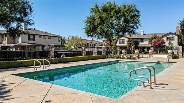 a swimming pool with outdoor seating and yard