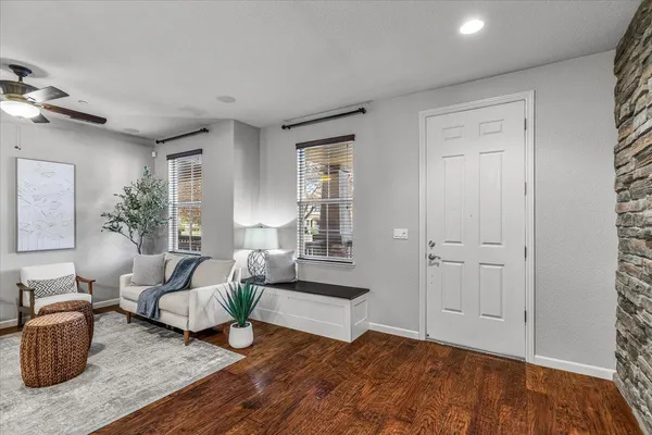 a living room with furniture and wooden floor