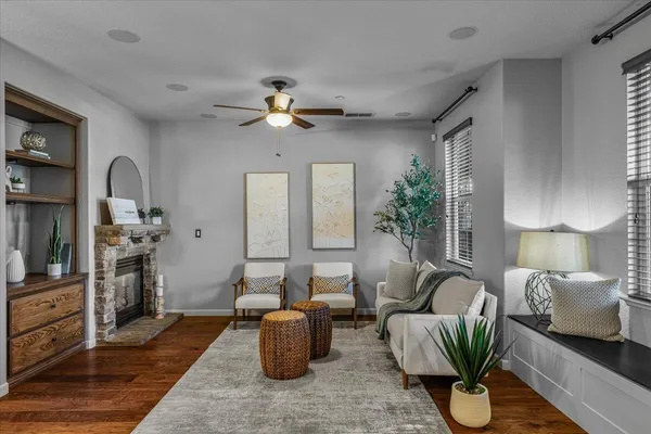 a living room with furniture potted plant and a table
