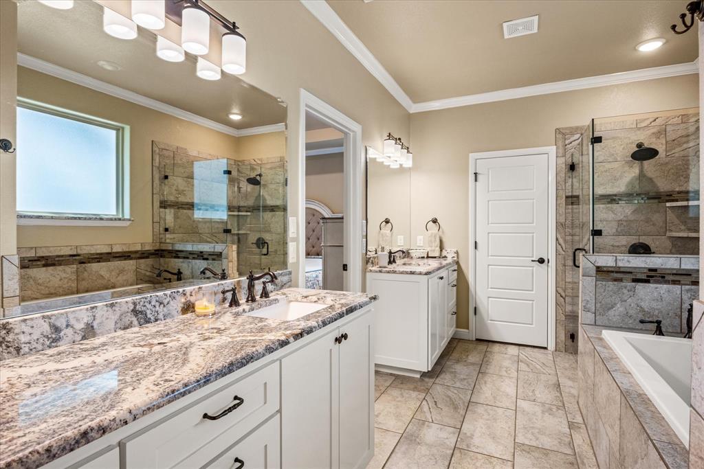 3868 Legend Trail Granbury, TX 76049 - Photo 18 of 39 Double vanities with granite counters, tile floors with separate soaker tub and shower.