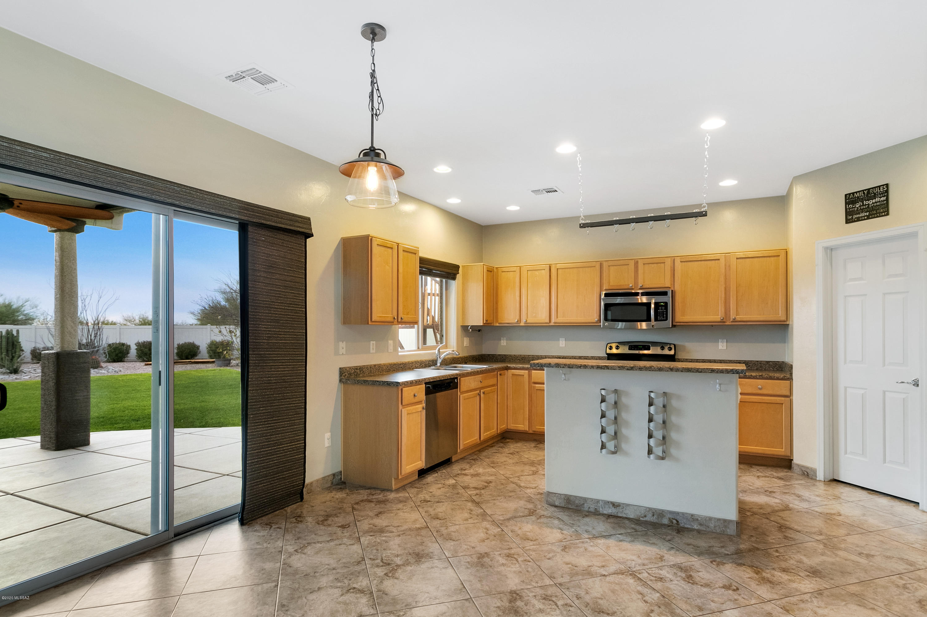 21027 East Treasure Road Red Rock, AZ 85145 - Photo 4 of 29 a kitchen with stainless steel appliances granite countertop a sink a stove and a refrigerator