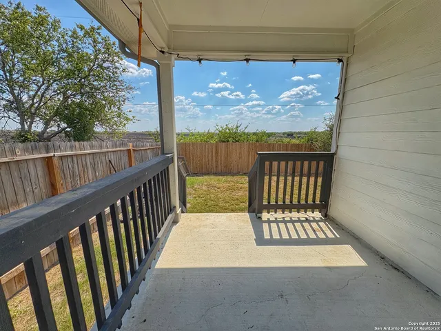 a view of a balcony with wooden floor