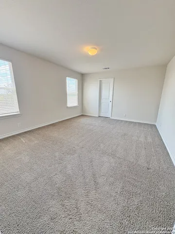 an empty room with windows and closet