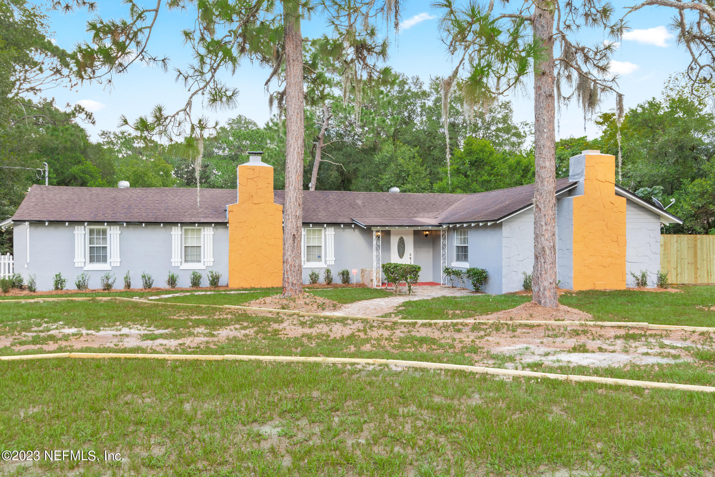 665 Lee Road Jacksonville, FL 32225 - Photo 1 of 58 a house view with a big yard and large trees