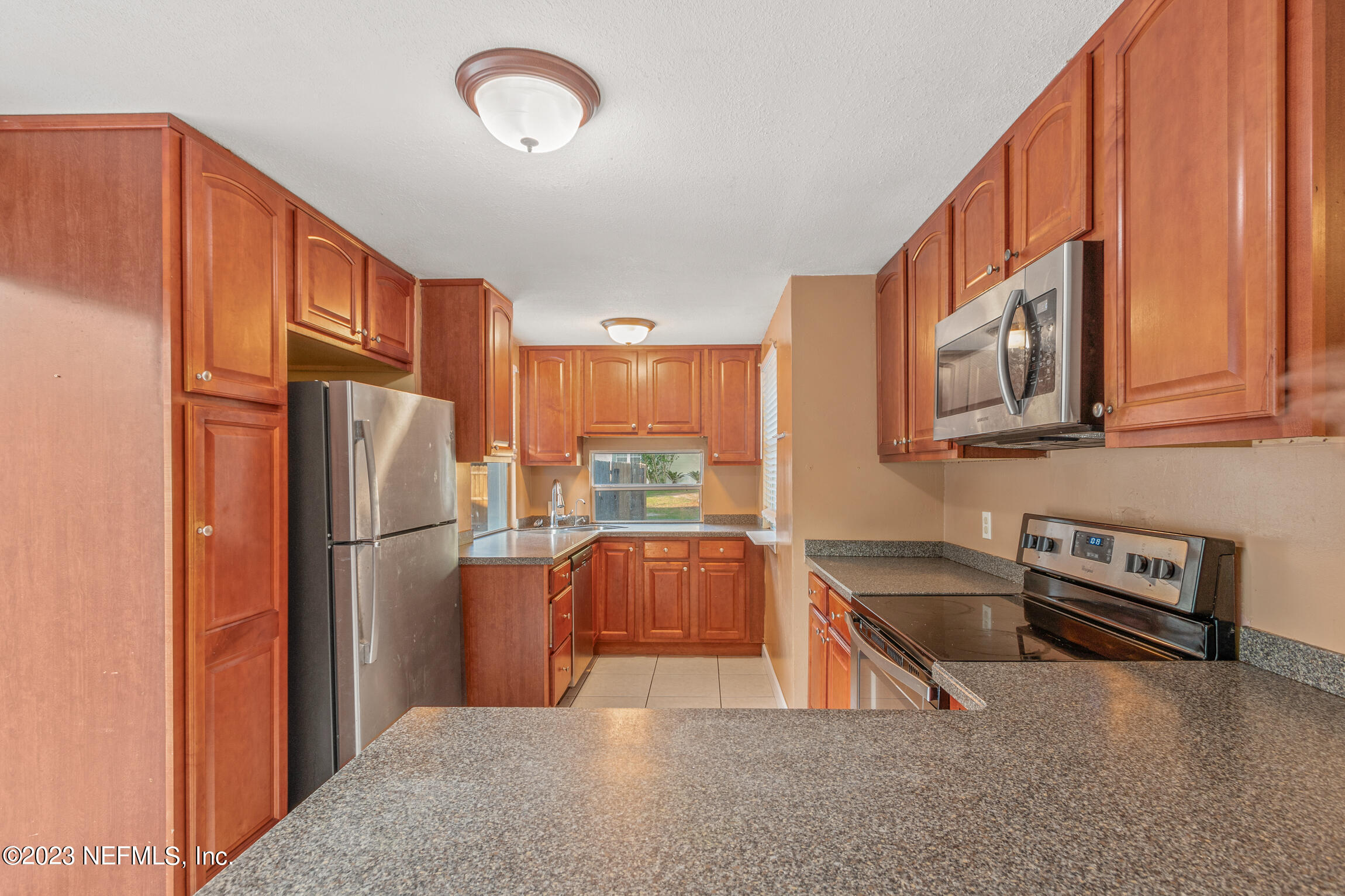 665 Lee Road Jacksonville, FL 32225 - Photo 12 of 58 a kitchen with stainless steel appliances granite countertop a refrigerator a stove and a sink