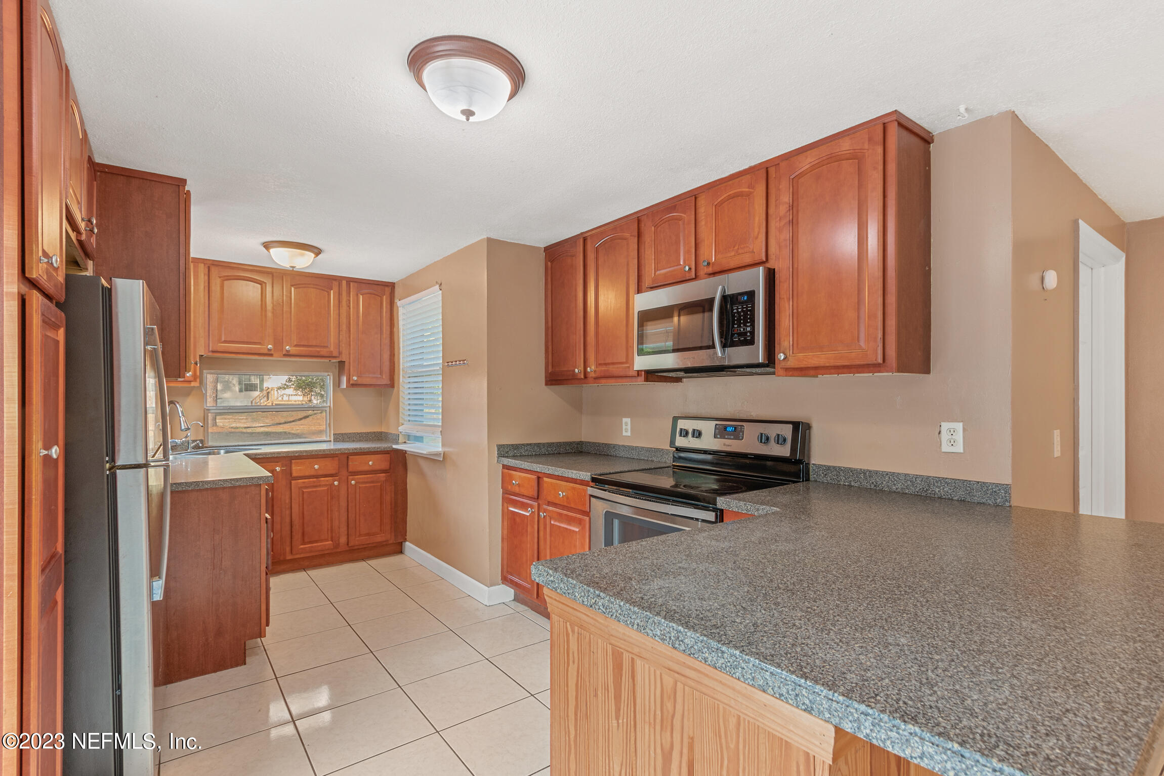 665 Lee Road Jacksonville, FL 32225 - Photo 13 of 58 a kitchen with stainless steel appliances granite countertop a refrigerator stove top oven and sink
