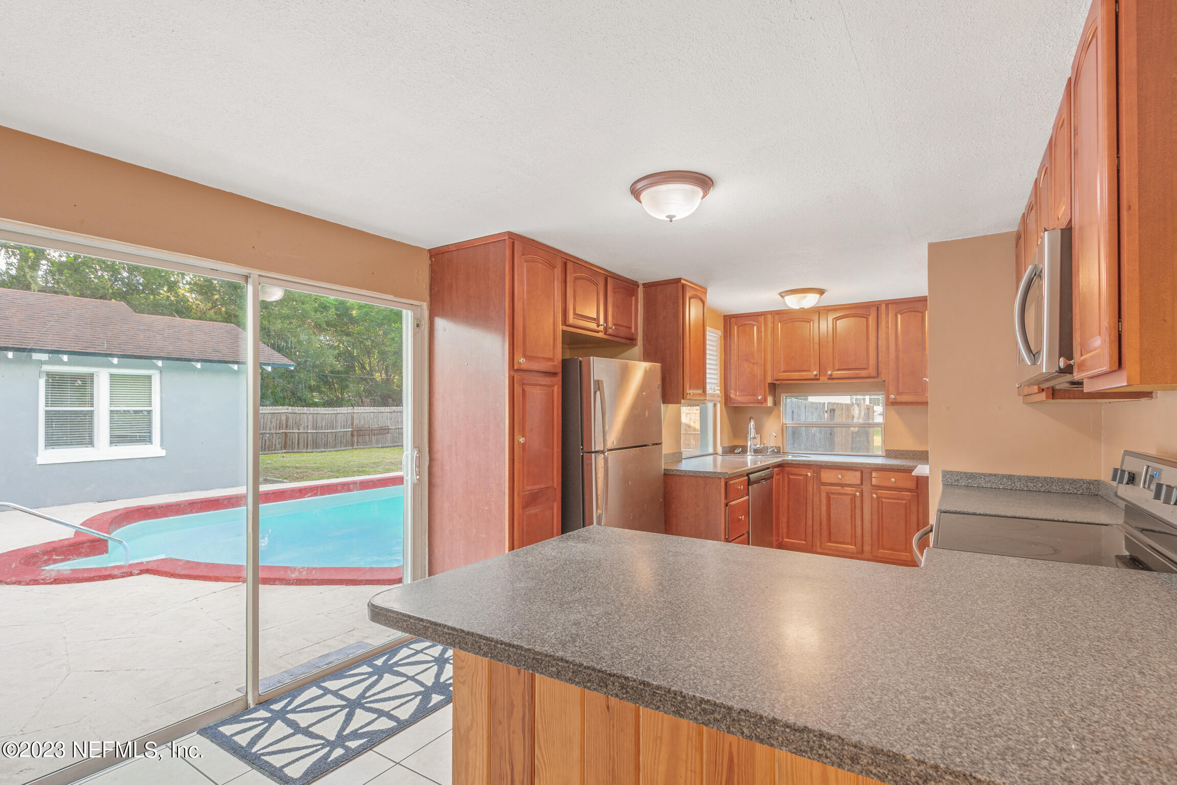 665 Lee Road Jacksonville, FL 32225 - Photo 14 of 58 a kitchen with stainless steel appliances granite countertop a refrigerator a stove and a sink with granite countertops