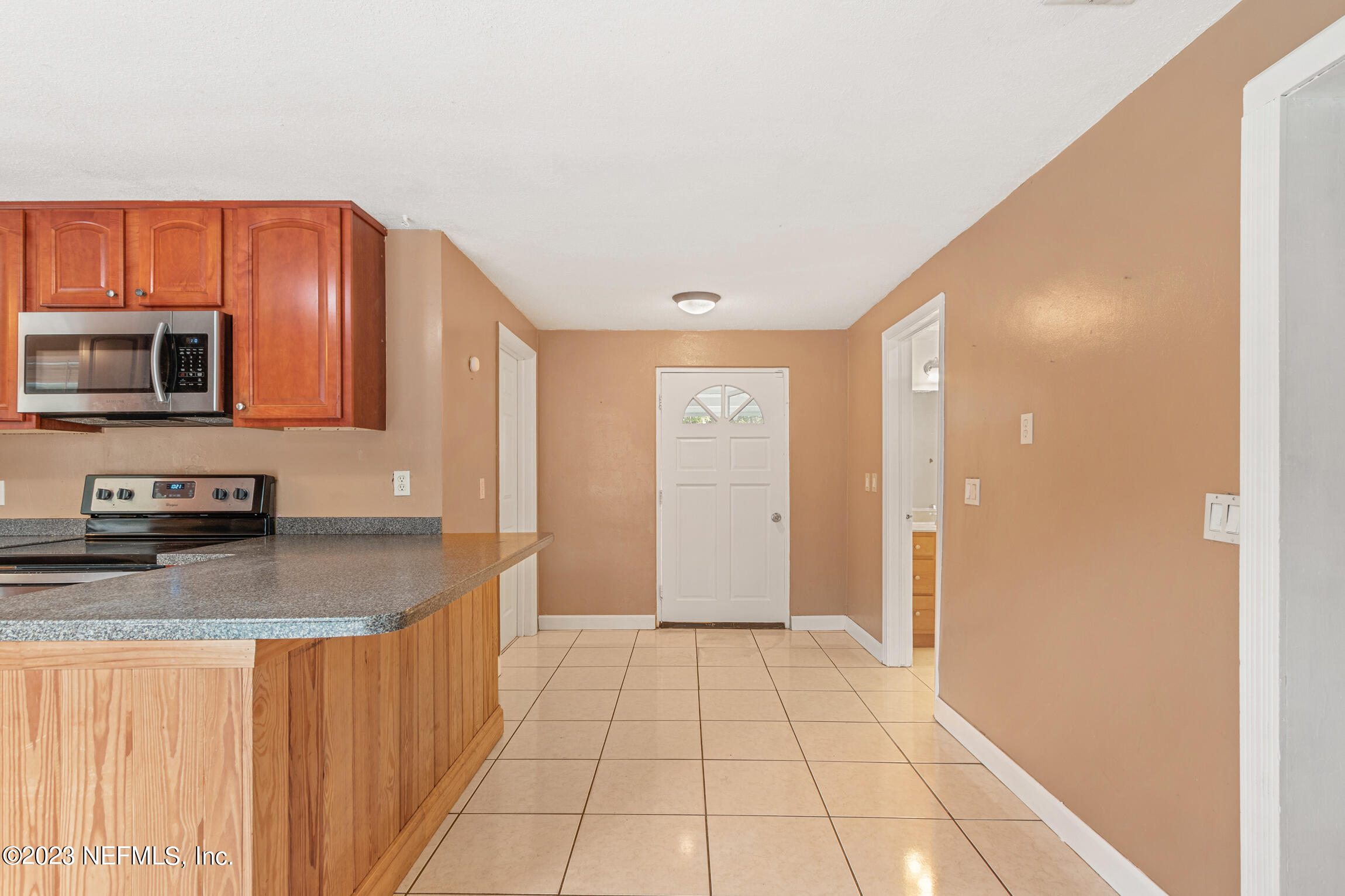665 Lee Road Jacksonville, FL 32225 - Photo 16 of 58 a kitchen with stainless steel appliances granite countertop a refrigerator and a stove top oven