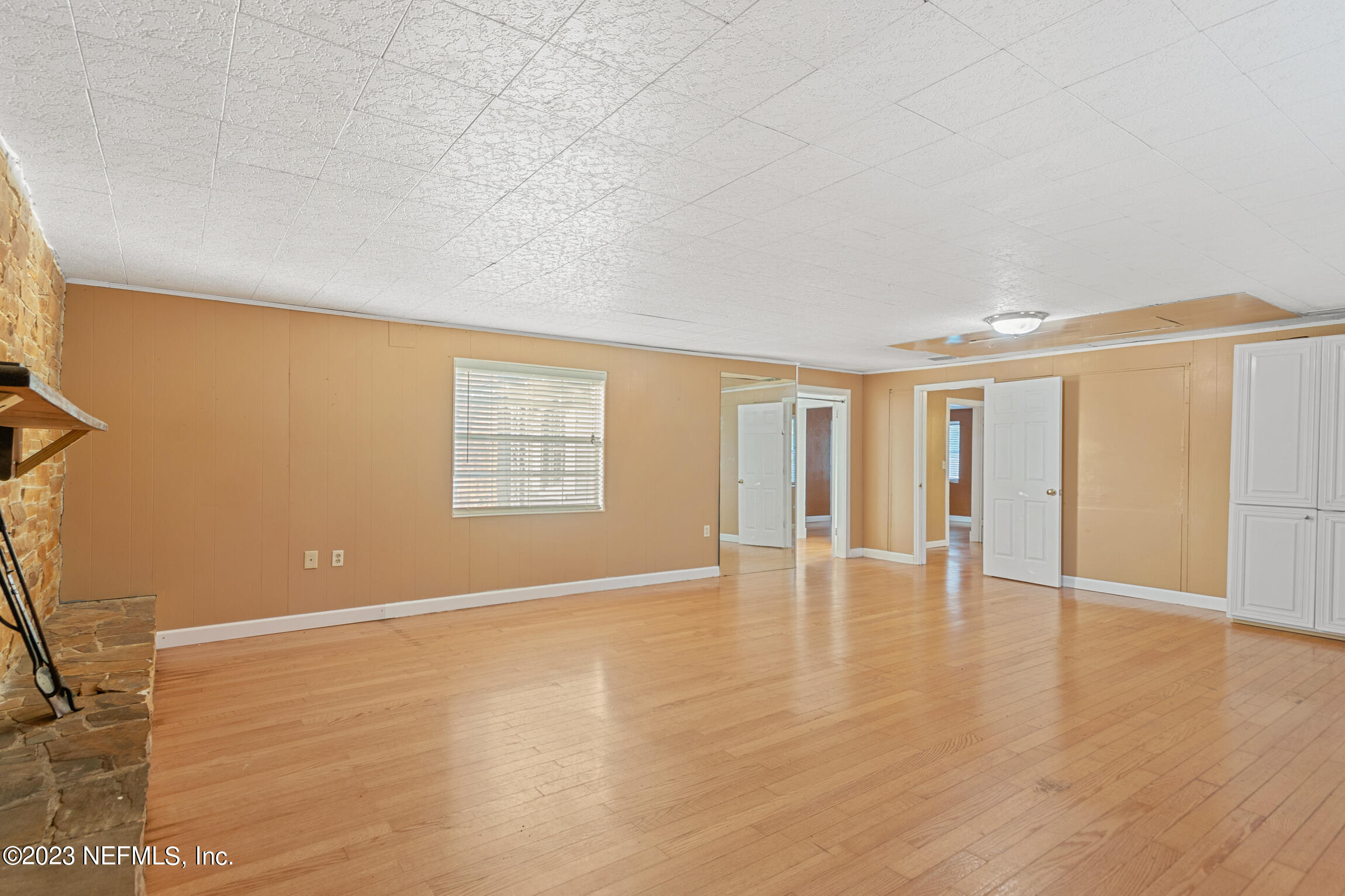 665 Lee Road Jacksonville, FL 32225 - Photo 19 of 58 a view of an empty room with wooden floor and a window