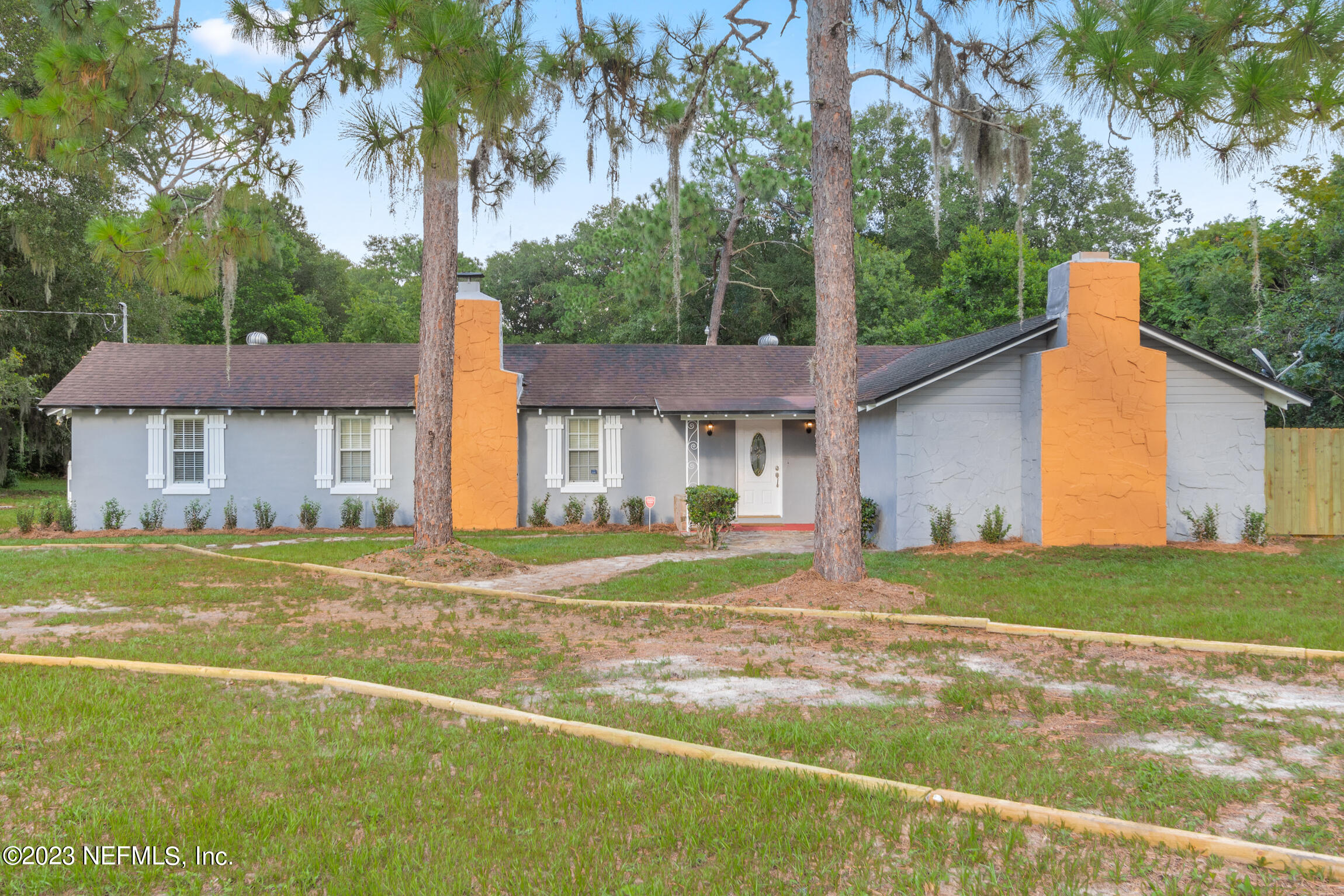665 Lee Road Jacksonville, FL 32225 - Photo 2 of 58 a view of a house with a yard and palm trees
