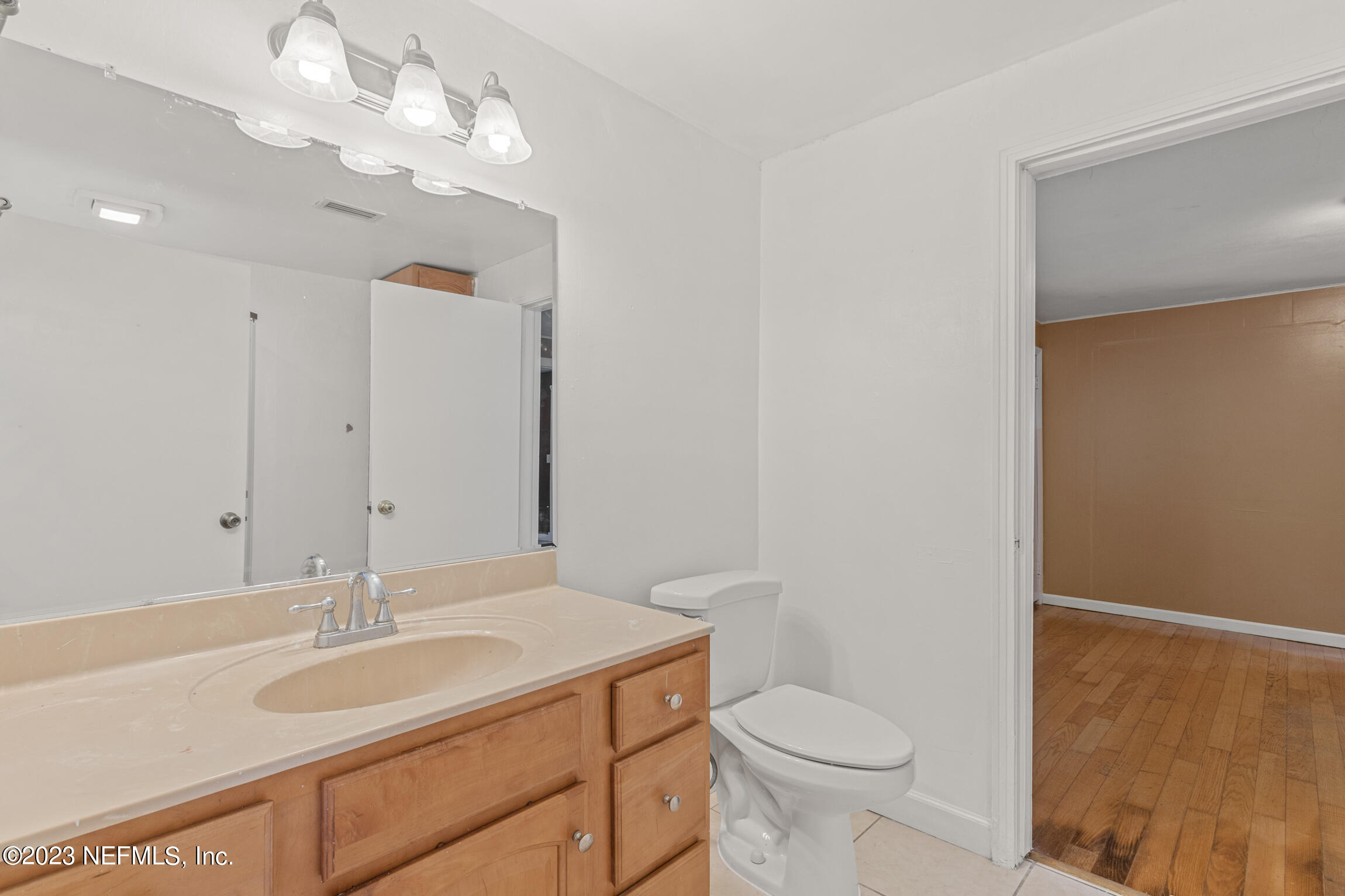 665 Lee Road Jacksonville, FL 32225 - Photo 21 of 58 a bathroom with a sink a toilet and a mirror