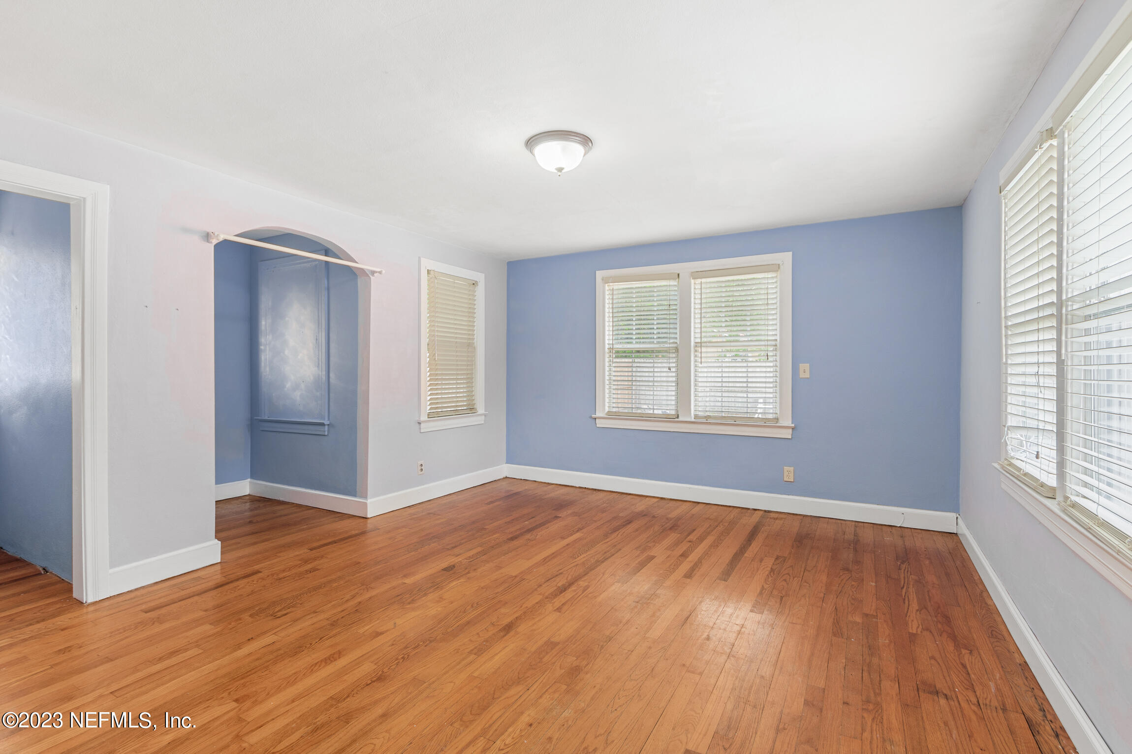 665 Lee Road Jacksonville, FL 32225 - Photo 23 of 58 an empty room with wooden floor and windows