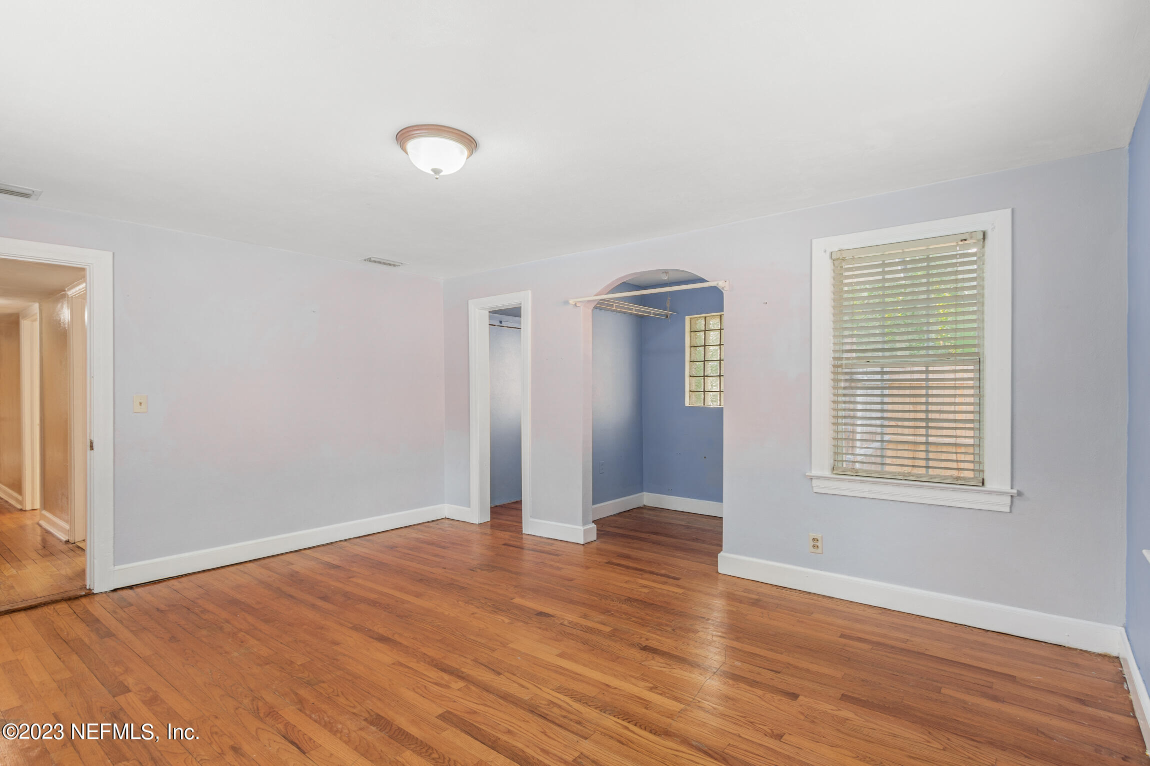 665 Lee Road Jacksonville, FL 32225 - Photo 24 of 58 an empty room with wooden floor and windows