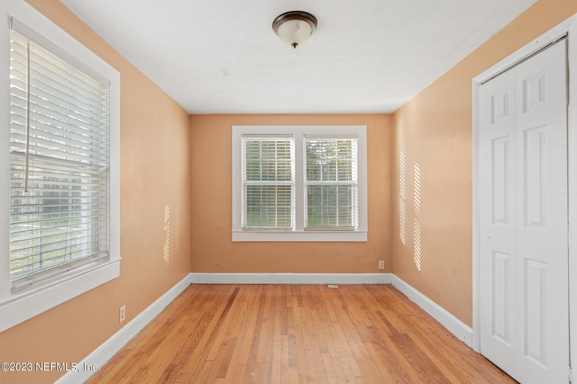 665 Lee Road Jacksonville, FL 32225 - Photo 25 of 58 a view of an empty room with wooden floor and a window