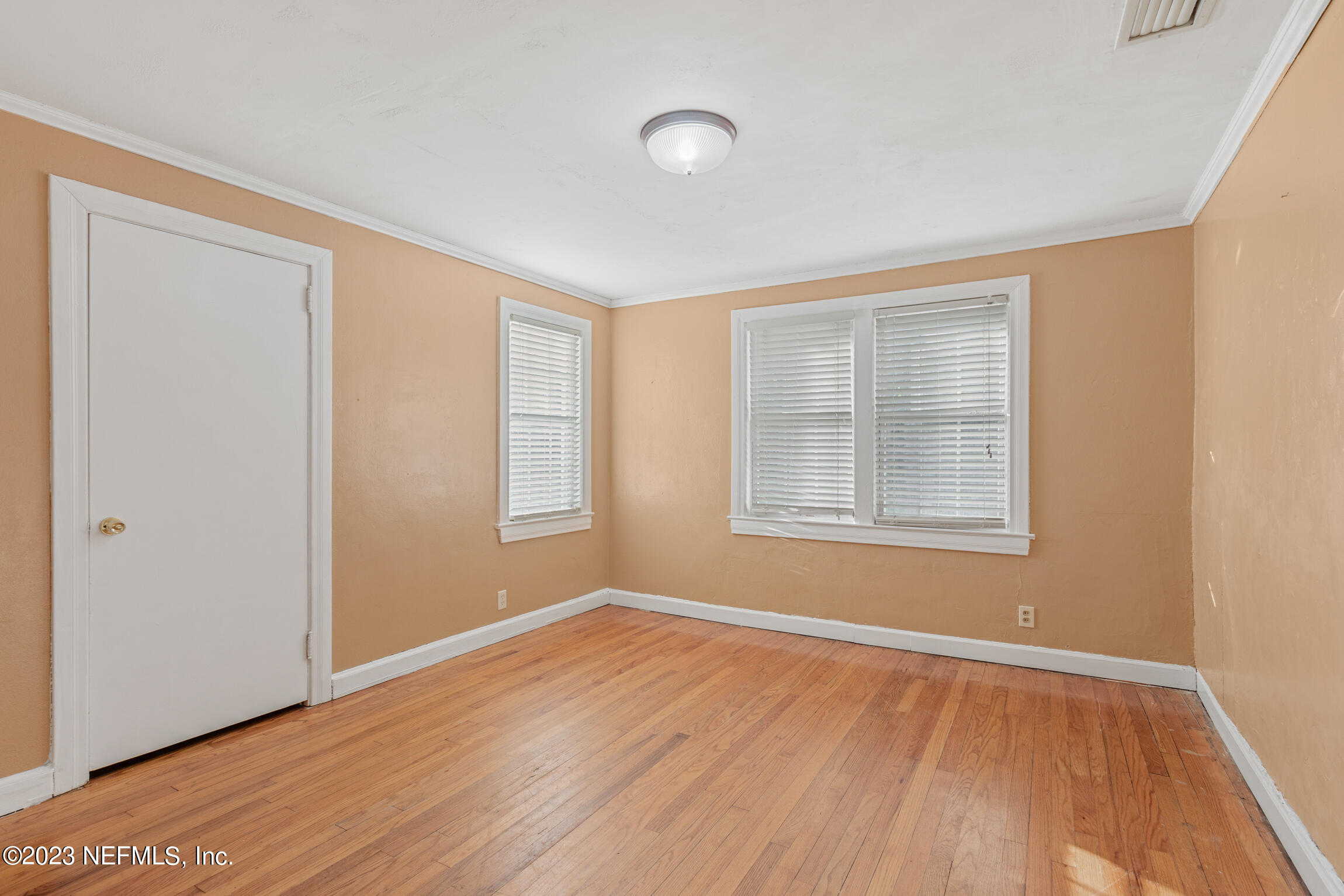 665 Lee Road Jacksonville, FL 32225 - Photo 26 of 58 a view of an empty room with wooden floor and a window