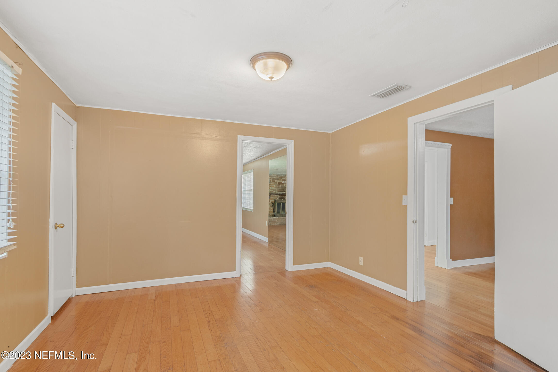 665 Lee Road Jacksonville, FL 32225 - Photo 28 of 58 a view of an empty room with wooden floor and a window