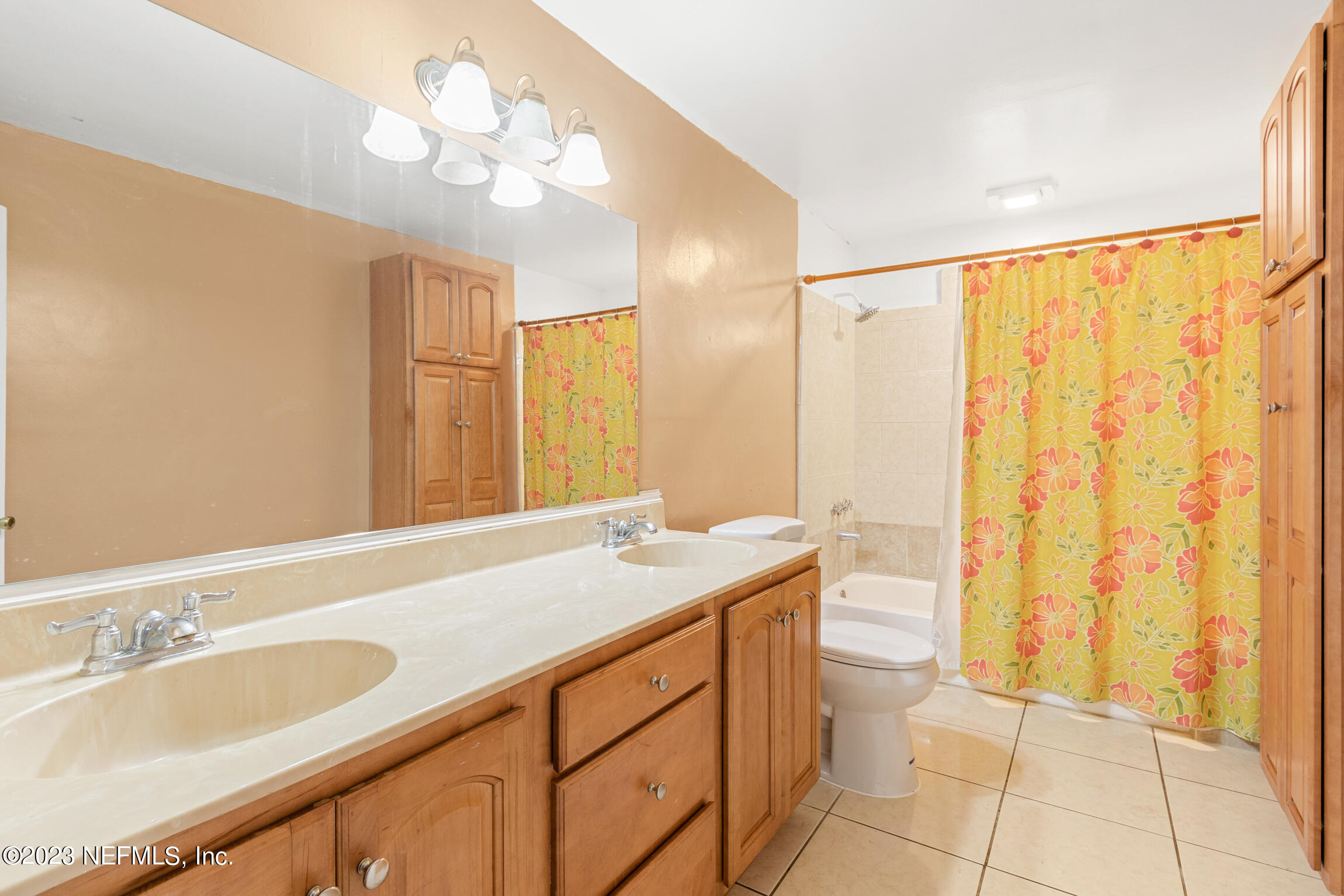 665 Lee Road Jacksonville, FL 32225 - Photo 29 of 58 a bathroom with a granite countertop sink a mirror and a shower
