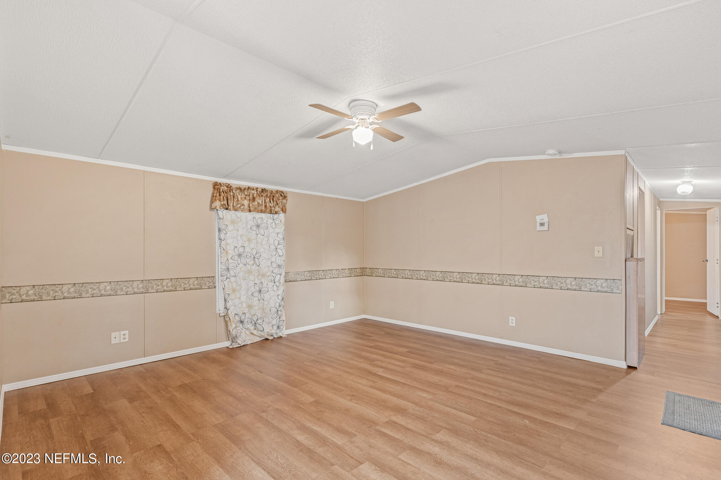 665 Lee Road Jacksonville, FL 32225 - Photo 39 of 58 a view of a livingroom with an empty space and a ceiling fan