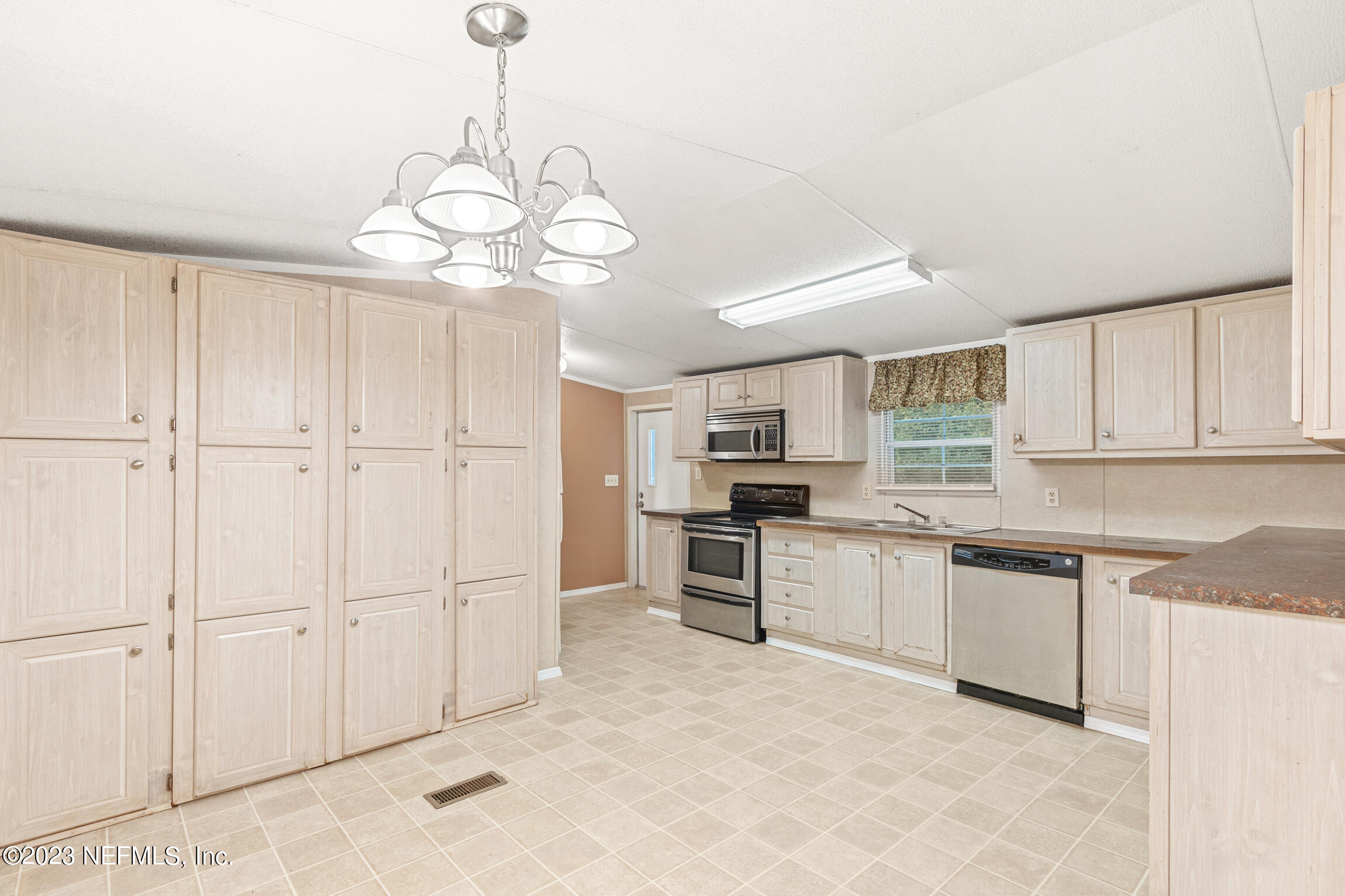 665 Lee Road Jacksonville, FL 32225 - Photo 40 of 58 a kitchen with white cabinets and white appliances
