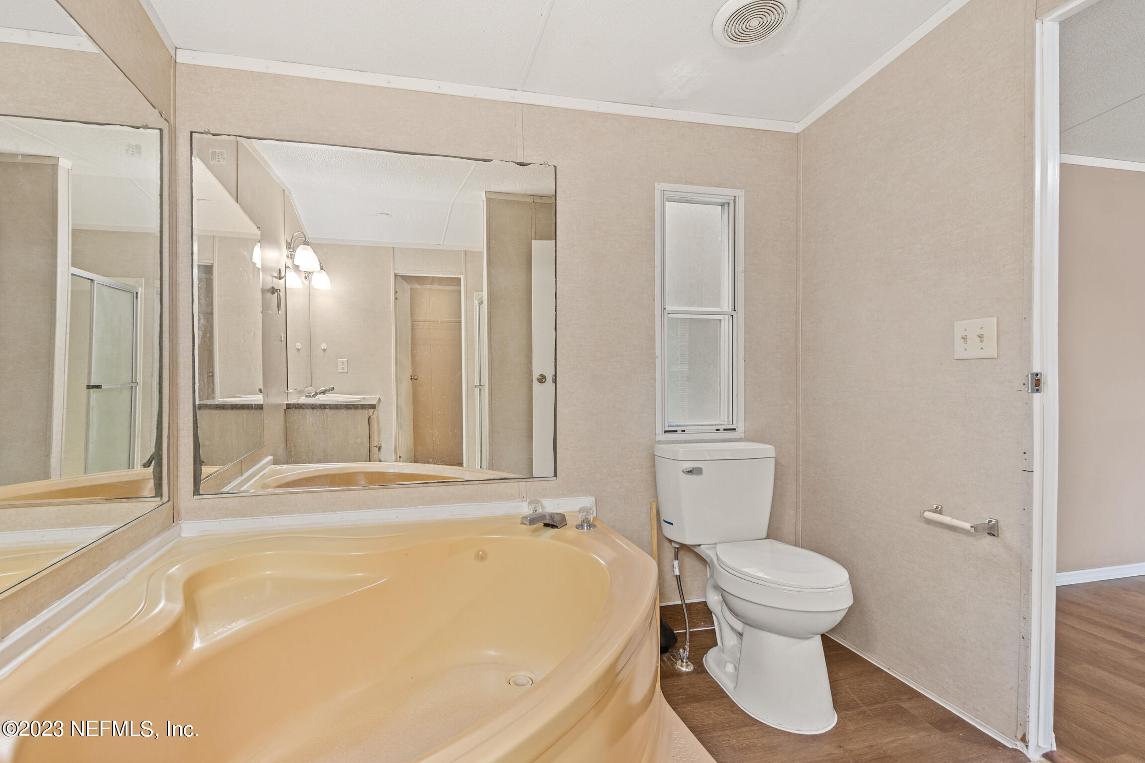 665 Lee Road Jacksonville, FL 32225 - Photo 45 of 58 a bathroom with a toilet and a bathtub