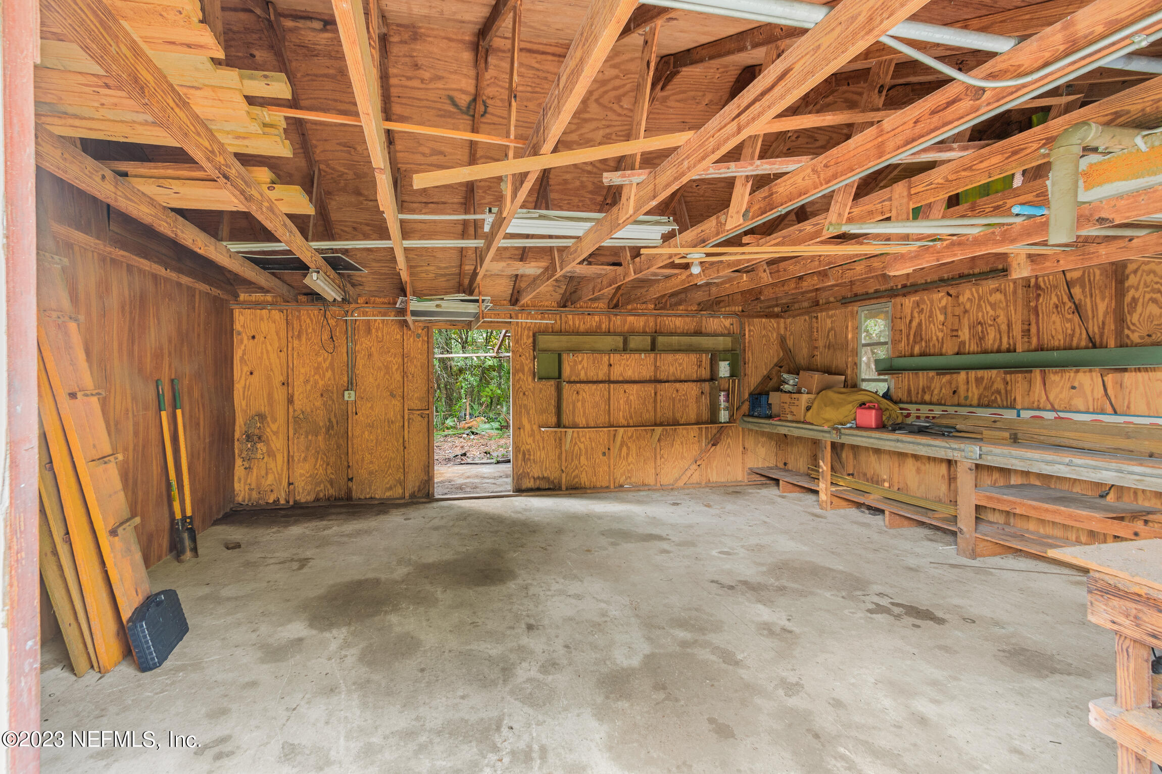 665 Lee Road Jacksonville, FL 32225 - Photo 51 of 58 a view of a garage with wooden table and chairs