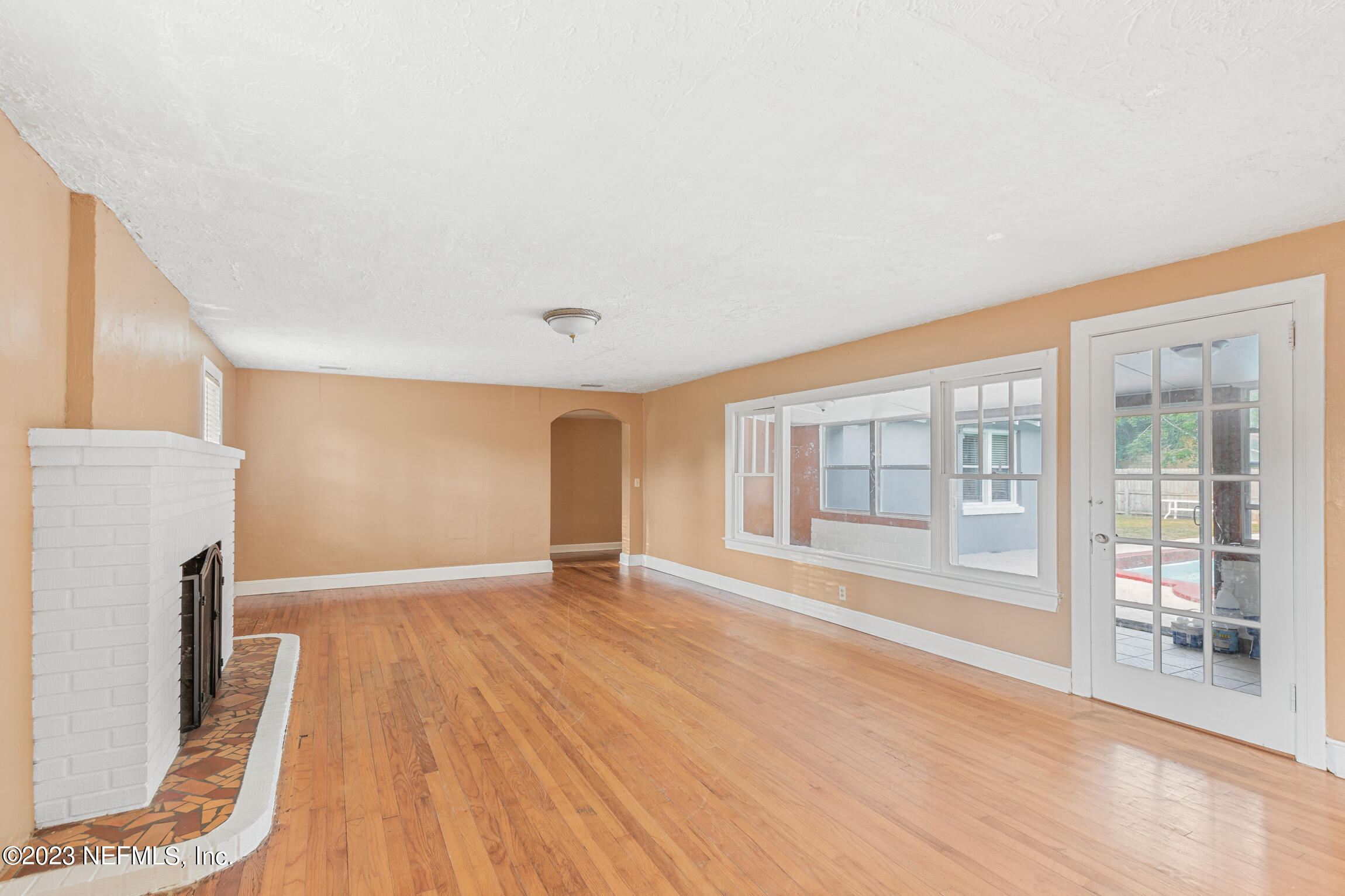 665 Lee Road Jacksonville, FL 32225 - Photo 7 of 58 a view of empty room with wooden floor and fan