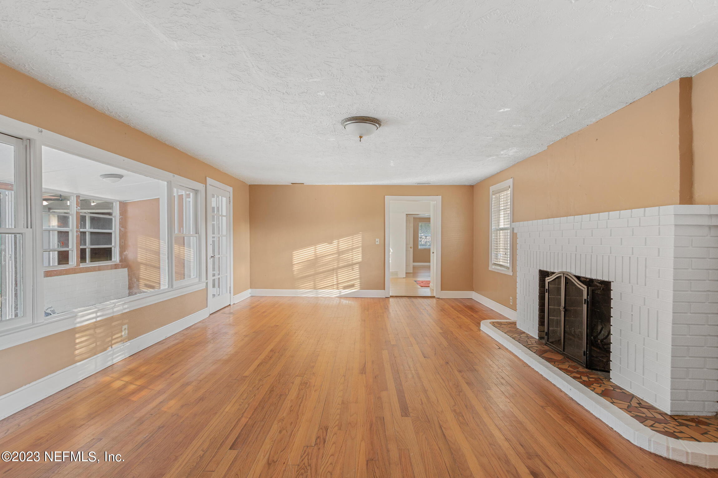665 Lee Road Jacksonville, FL 32225 - Photo 8 of 58 a view of an empty room with wooden floor and a window