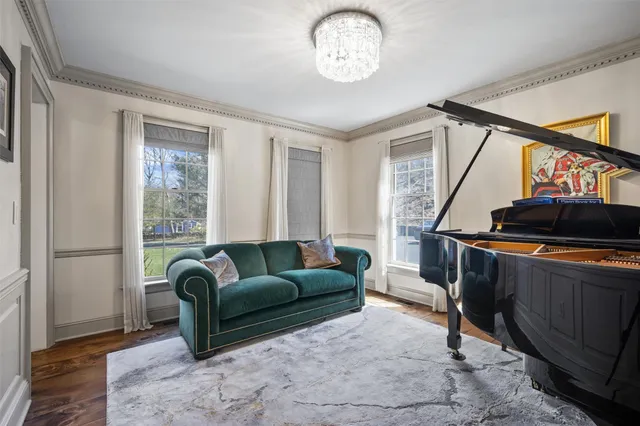 a spacious bedroom with a bed and glass windows