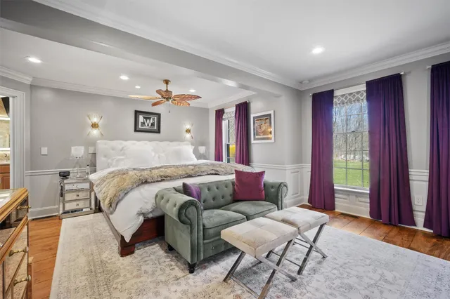 a bathroom with a granite countertop sink a mirror and a toilet