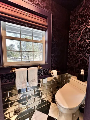 a view of a patio with table and chairs and wooden floor