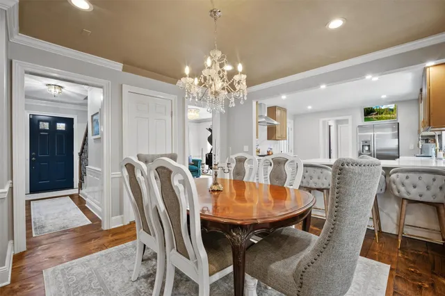 a view of a dining room with furniture and chandelier