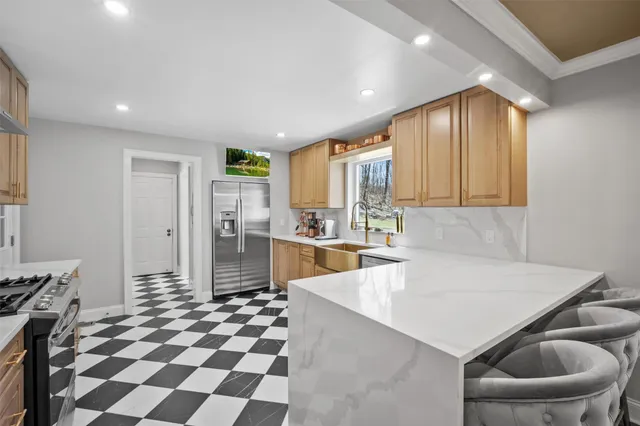 a kitchen with a sink a refrigerator and cabinets