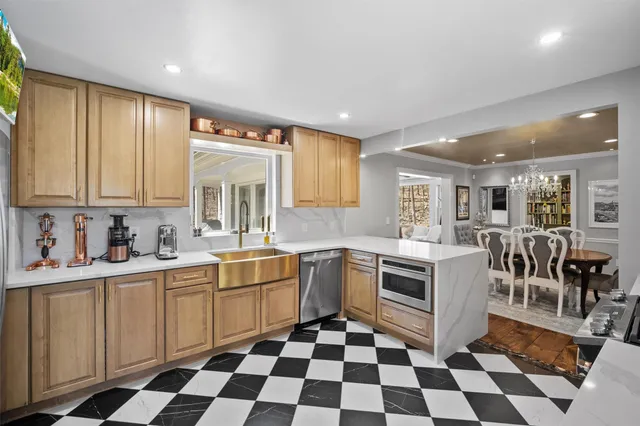 a kitchen with a sink a stove and cabinets