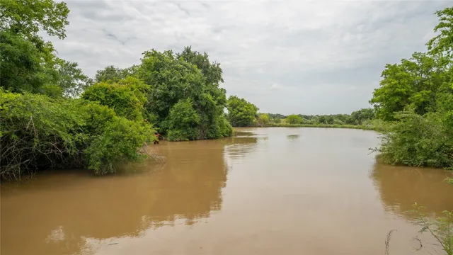 a view of a lake with houses in the background