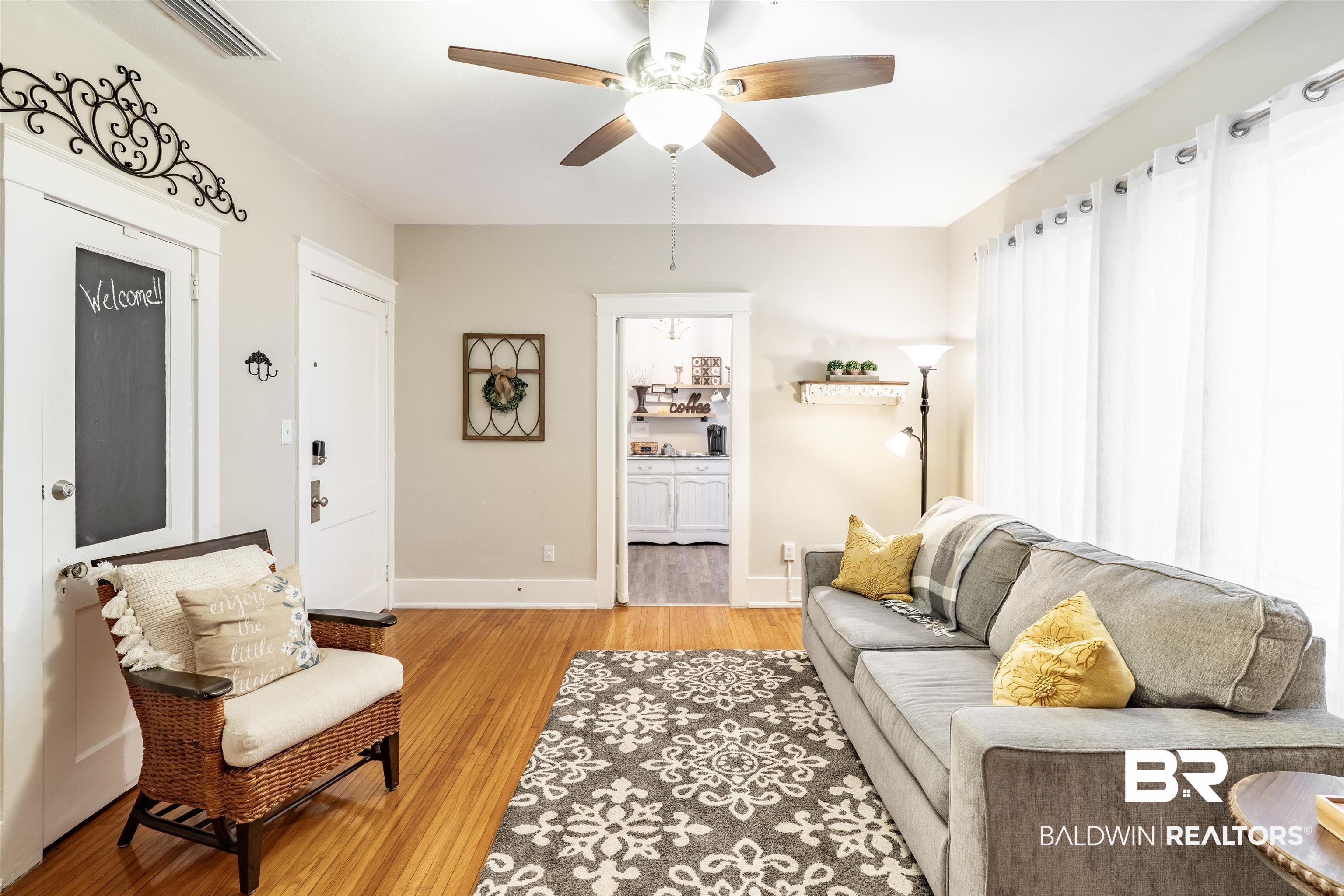 1600 Government Street, Unit 3F Mobile, AL 36604 - Photo 11 of 18 Living room with ceiling fan, light wood-style flooring, and baseboards