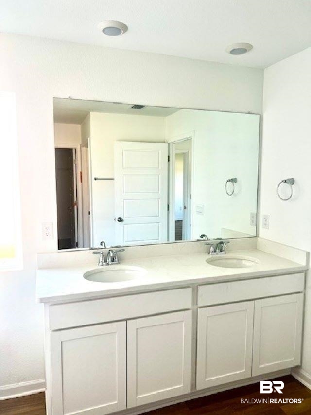 32063 Lyon Road Daphne, AL 36527 - Photo 3 of 4 Bathroom featuring hardwood / wood-style flooring and vanity