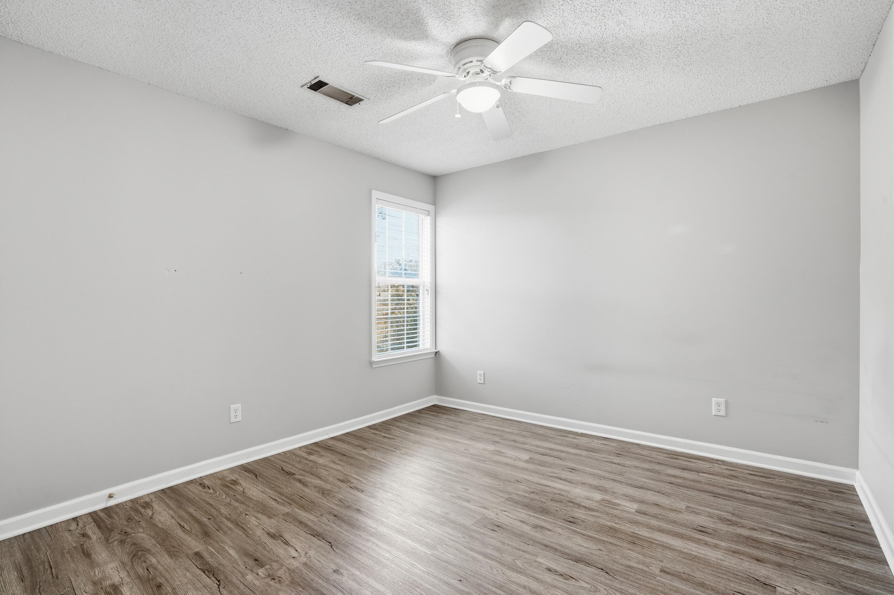 8570 May Orchard Lane Cordova, TN 38018 - Photo 20 of 35 Unfurnished room featuring wood finished floors, a textured ceiling, and a ceiling fan