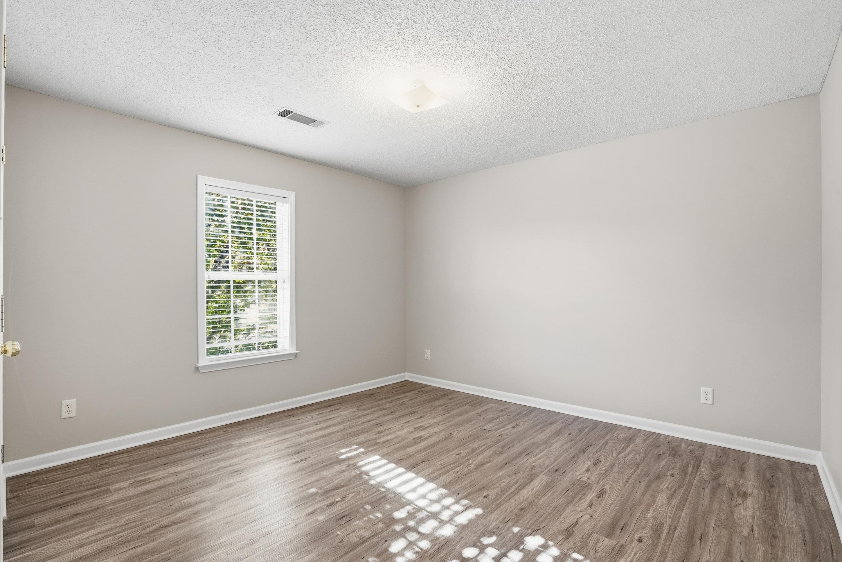 8570 May Orchard Lane Cordova, TN 38018 - Photo 22 of 35 Unfurnished room with wood finished floors and a textured ceiling