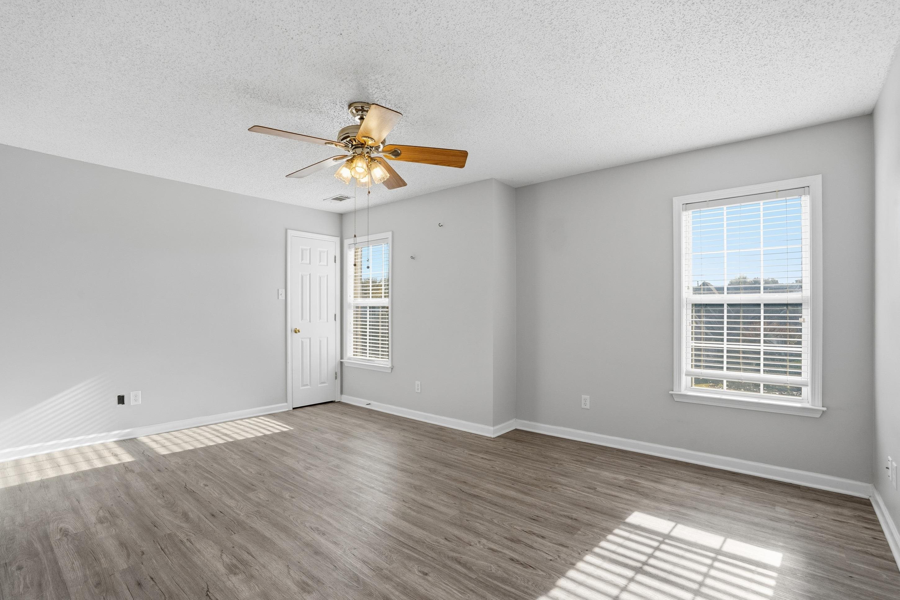 8570 May Orchard Lane Cordova, TN 38018 - Photo 25 of 35 Spare room featuring a textured ceiling, light wood-type flooring, and a ceiling fan