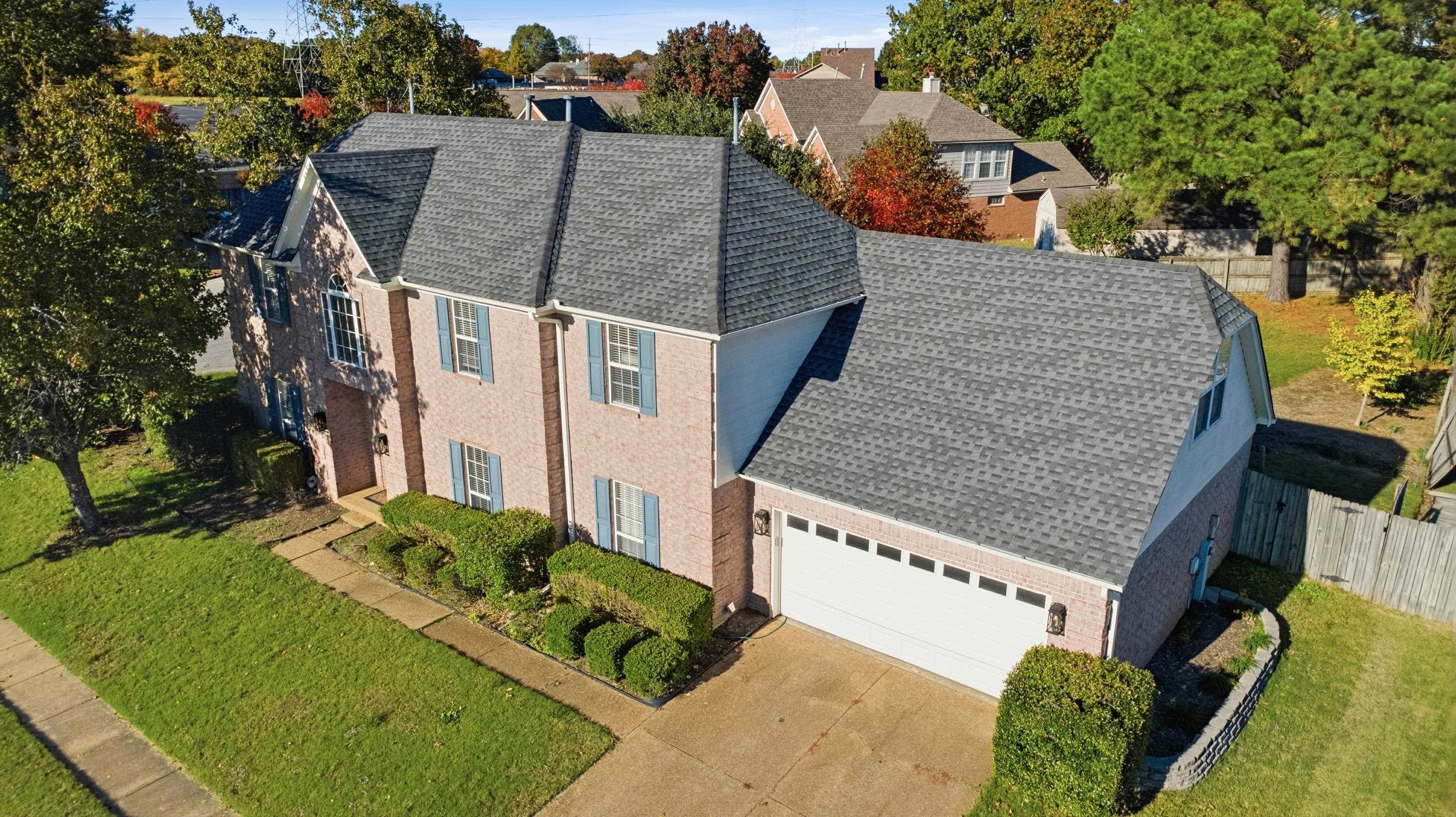 8570 May Orchard Lane Cordova, TN 38018 - Photo 30 of 35 View of front of property featuring a shingled roof, driveway, brick siding, and a garage