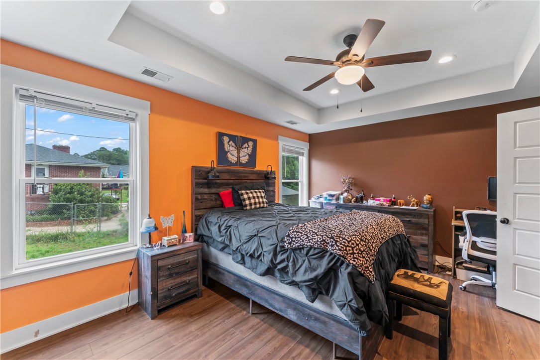 429 Nelson Drive Anderson, SC 29621 - Photo 16 of 32 A comfortable bedroom features high ceilings, recessed lighting, and ample natural light from two large windows.