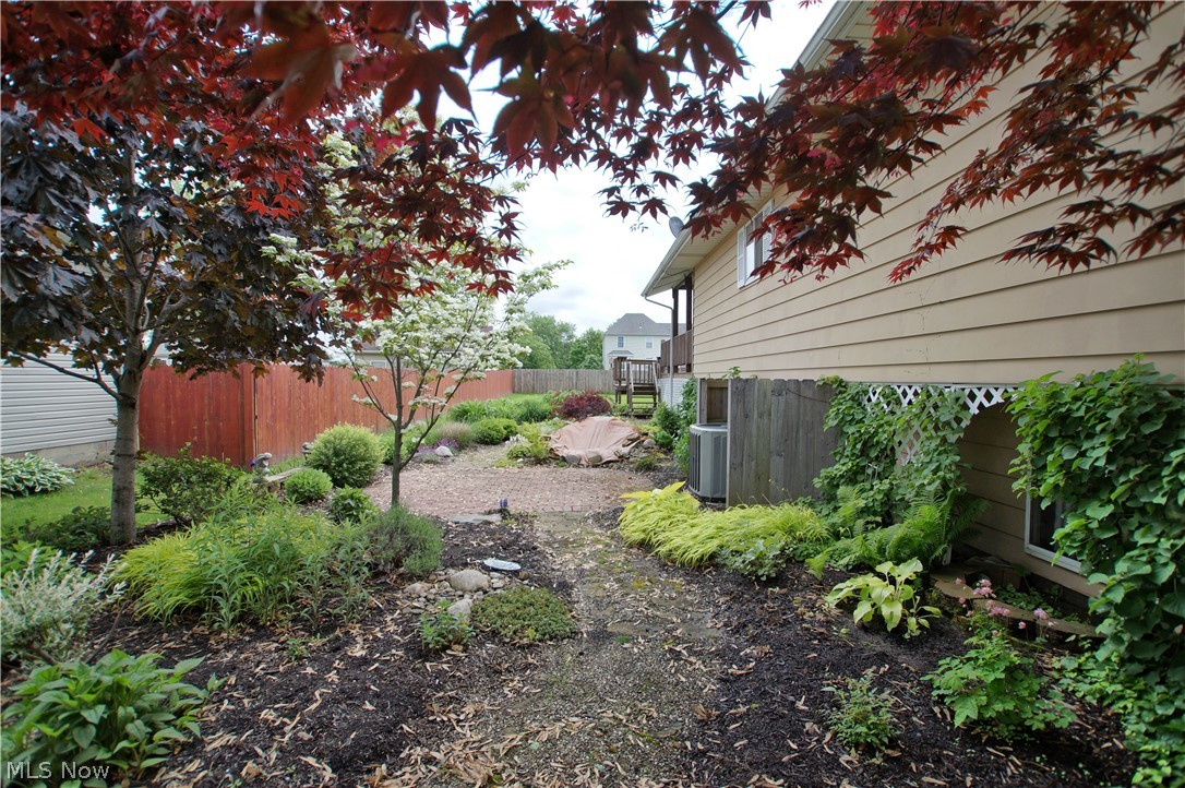 4009 Dayton Road Madison, OH 44057 - Photo 26 of 32 North side offers a landscaped path to the Backyard.